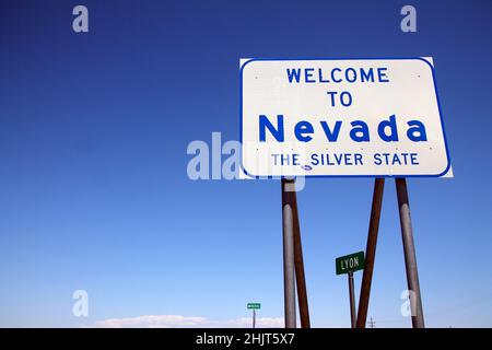 L'indicazione stradale all'entrata del Nevada che proviene dal deserto della California nella costa occidentale Foto Stock