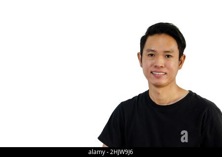 Uomo asiatico che indossa una t-shirt nera sorridente mostrando denti su sfondo bianco. Foto Stock