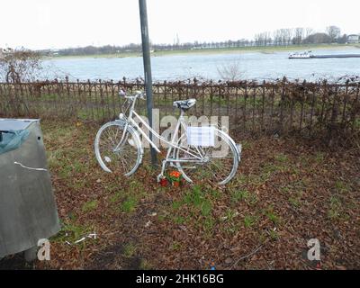 Colonia, Germania. 23rd Jan 2022. Una bici bianca fantasma - bici dipinta di bianco che non ride - ma ricordati. Con le cosiddette biciclette fantasma, il Club tedesco della bicicletta ha creato un luogo di ricordo per i ciclisti morti in incidenti. Credit: Horst Galuschka/dpa/Alamy Live News Foto Stock