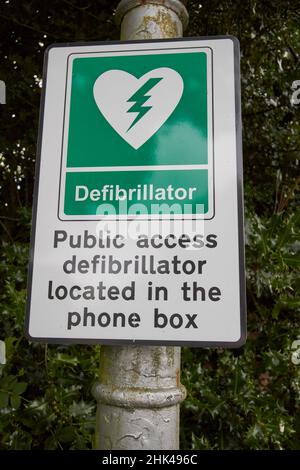 cartello per defibrillatore nella vecchia scatola telefonica bt vicino al distretto di sawrey lake, cumbria, inghilterra, regno unito Foto Stock