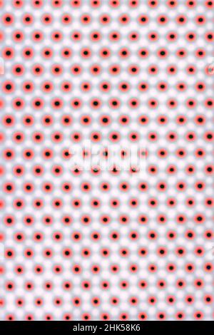 Ripetizione ipnotizzante di molti piccoli punti rossi e neri su sfondo bianco. Foto Stock