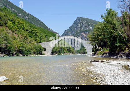 Grecia, Epiro, ponte in pietra ad arco ricostruito di Plaka sul fiume Arachthos, il più grande ponte in pietra ad arco singolo dei Balcani Foto Stock