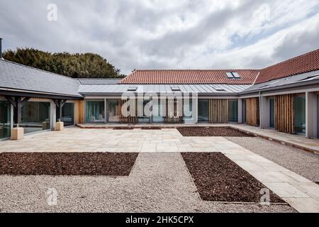 Trumpington, Cambridgeshire - Maggio 04 2017: Facciata esterna e l'elevazione del contemporaneo fienile conversione fornendo nuove case di lusso da ex rosso Foto Stock