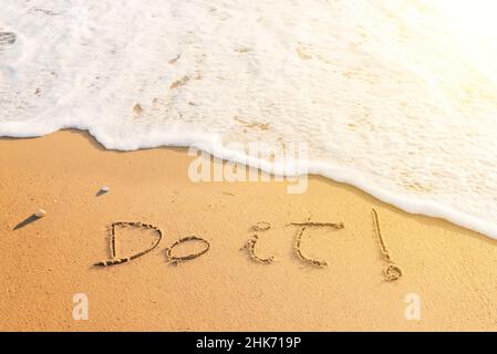 Parola 'Do it' scritta sulla sabbia della spiaggia. Messaggio positivo scritto sulla riva al tramonto Foto Stock