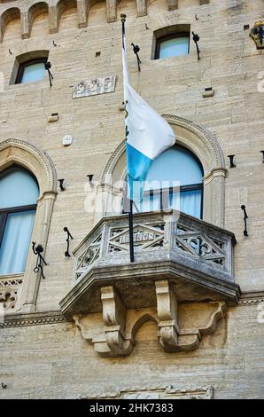 Il Palazzo del Governo della Repubblica di San Marino con la bandiera di San Marino che vola dal balcone nella piazza centrale della città Foto Stock