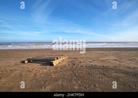 Pesante zattera di legno lavata su una spiaggia Foto Stock