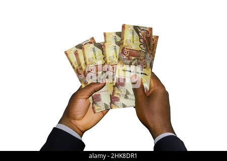 Mani nere in tuta con 3D note di Kenia Shilling Foto Stock