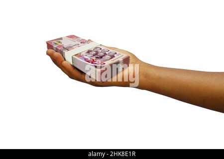 Mano Holding 3D reso stack di Ghanaian cedi note isolate su sfondo bianco Foto Stock