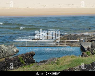 Il blu e il verde della piscina di acqua salata Rock, la spiaggia di sabbia e mare di Sawtell Australia. Estate Foto Stock