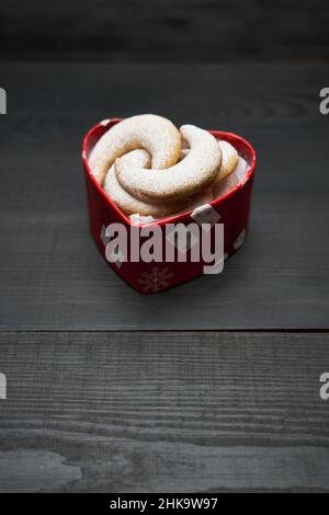 Confezione regalo a forma di cuore piena di biscotti Kipferl alla vaniglia tradizionali tedeschi o austriaci Vanillekipferl Foto Stock