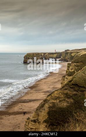 La vista lungo la baia di Marsden vicino a Sunderland, delle scogliere e delle montagne di arenaria del mare, quando la marea entra Foto Stock