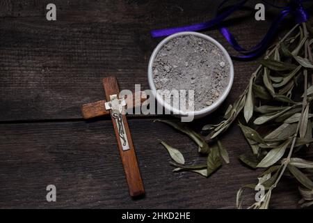 bowl with ashes and olive branch. ash wednesday concept Stock Photo