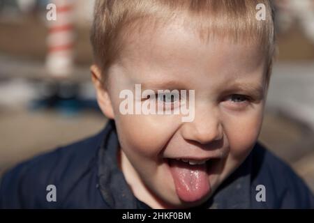 Umea, Norrland Svezia - 17 aprile 2021: Il piccolo ragazzo pia attacca la sua lingua Foto Stock