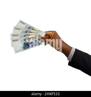 Mano nera 3D reso 2000 dinari algerini note isolate su sfondo bianco Foto Stock