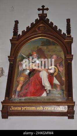 Una raffigurazione religiosa di Gesù che cade portando una croce sulle sue spalle nella Chiesa Cappuccina di nostra Signora di Lourdes a Fiume. La chiesa è un'esposizione unica Foto Stock