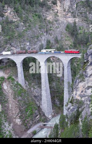 Il treno merci va da Chur a St. Moritz sul viadotto Landwasser. Alpi svizzere. Foto Stock