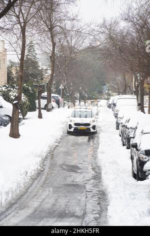 Mevasseret Zion, Israele - 27th gennaio 2022: Pattugliata della polizia cittadina in una strada coperta di neve, dopo una rara tempesta di neve nei monti della Giudea. Foto Stock