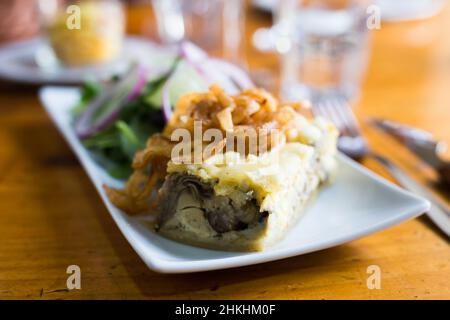 Torta tradizionale francese con pancetta e formaggio - quiche lorraine, con verdure Foto Stock