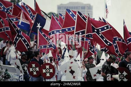 Houston Texas USA, 1990: Membri del gruppo supremacista bianco Ku Klux Klan marzo centro portando bandiere confederate. ©Bob Daemmrich Foto Stock