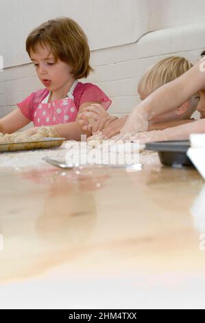 Bambini impastare pasta, credito: Photoshot Creative / Stuart Cox / Avalon Foto Stock