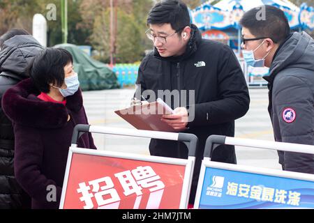 NANTONG, CINA - 8 FEBBRAIO 2022 - i cercatori di lavoro cercano informazioni ad una fiera di lavoro a Nantong, nella provincia di Jiangsu della Cina orientale, il 8 febbraio 2022. Foto Stock