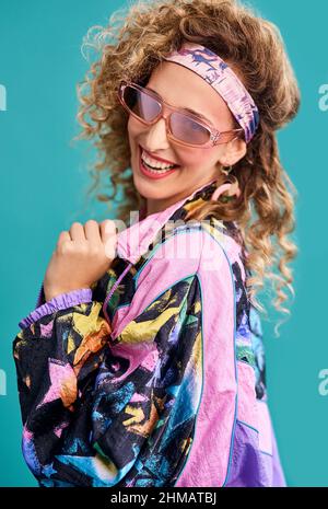 Ispirato al 80s. Studio girato di una bella giovane donna che indossa un vestito 80s. Foto Stock