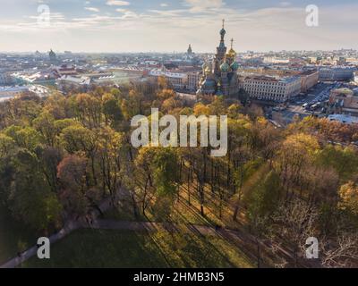 Veduta aerea della cattedrale Chiesa del Salvatore sul sangue e parco Mikhaylovskiy al tramonto, cupola dorata, tetti di San Pietroburgo, ombre di alberi Foto Stock