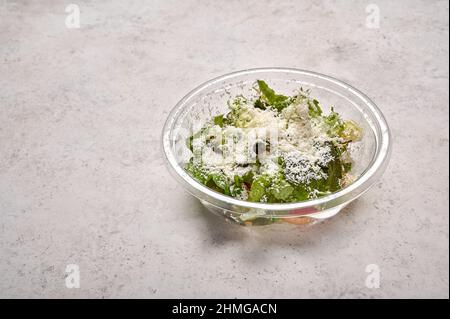 Insalata fresca di verdure fresche con formaggio in contenitore trasparente di plastica. Concetto di cibo di design per il take away o la consegna Foto Stock