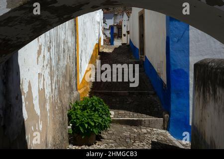 Ammira l'arco di un tranquillo passaggio a Óbidos, Centro, Portogallo Foto Stock