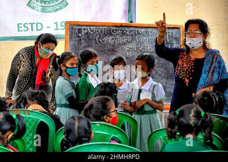 Kolkata, India. 10th Feb 2022. Gli insegnanti hanno visto insegnare gli studenti durante le lezioni all'aperto. Il governo del Bengala occidentale ha dato il permesso di tenere classi a cielo aperto per gli studenti di classe VII (sette) e inferiore dalla settimana corrente in poi, dopo due anni di restrizioni del codice-19. (Foto di Avishek Das/SOPA Images/Sipa USA) Credit: Sipa USA/Alamy Live News Foto Stock