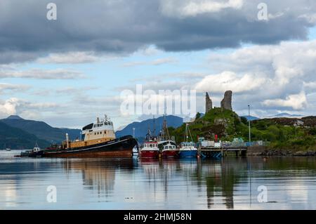 Vista delle navi da pesca ormeggiate a Kyleakin, Isola di Skye con Castello Moil in background, Scozia, Regno Unito Foto Stock