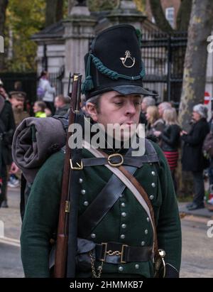Reenactor vestito in uniforme Battle of Waterloo guarda verso il basso mentre marches nello spettacolo del Signore Sindaco del 2021, Victoria Embankment, Londra. Foto Stock