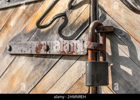 Lucchetto arrugginito blocca le vecchie porte di legno della caserma 18th secolo Foto Stock