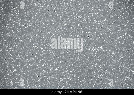 Texture. Rivestimento in granito antiaderente. Piccole macchie bianche e nere su sfondo grigio. Primo piano. Alta risoluzione. Profondità di campo completa. Foto Stock