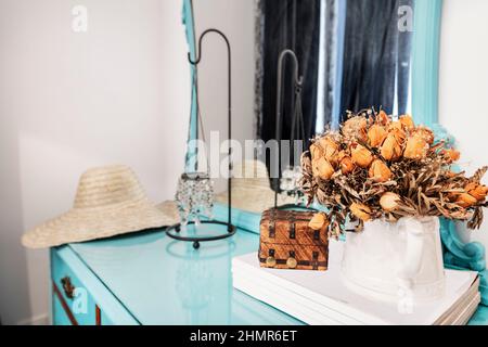 bouquet di fiori secchi su un comò di legno dipinto di blu Foto Stock