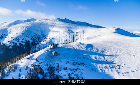 Vista aerea della cappella di Maria Schnee in Austria in una splendida giornata invernale Foto Stock