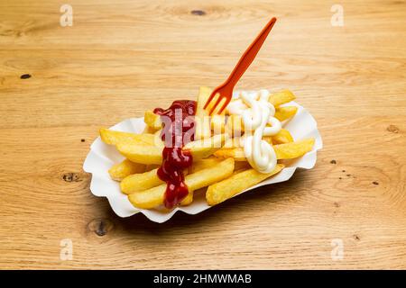 guscio di patatine fritte con ketchup e maionese Foto Stock