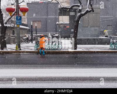 Pechino, Cina. 13th Feb 2022. Gli operatori sanitari sgusciano la neve a Pechino, capitale della Cina, 13 febbraio 2022. Domenica una nevicata ha colpito Pechino. Credit: LU Peng/Xinhua/Alamy Live News Foto Stock