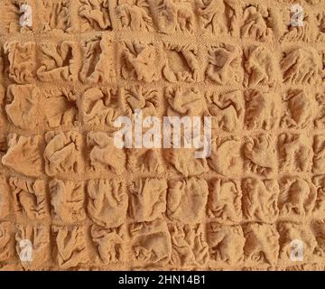 Tessuto motivo sfondo di un tovagliolo di waffle beige marrone come tessuto goffrato senza cuciture. Foto Stock