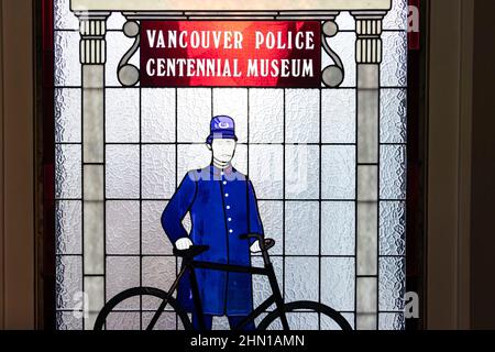 Vetrata colorata che mostra poliziotto vittoriano e bicicletta al museo della polizia di Vancouver Foto Stock