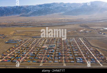 (220214) -- ZHANGJIAKOU, 14 febbraio 2022 (Xinhua) -- Foto aerea scattata il 25 novembre 2021 mostra la città natale di Torsongan Bullik in Zalmute Township, Contea di Wenquan, regione autonoma di Xinjiang Uygur nella Cina nord-occidentale. Nato in una famiglia di pastori nell'area pastorale della contea di Wenquan nella regione autonoma di Xinjiang Uygur nella Cina nord-occidentale, il Bullik Torsongan, di 27 anni, ha molte identità: pastore, maratoniere, ciclista e sciatore. Ora lavora come sciatore di prova per le Olimpiadi invernali di Pechino 2022. Molto prima dell'inizio della partita di sci di fondo delle Olimpiadi invernali di Pechino, il sentiero s Foto Stock