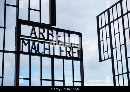 Le porte aperte del campo di concentramento di Sachsenhausen a Oranienburg, Germania. L'iscrizione 'Arbeit Macht Frei' ('il lavoro ti libera') sul cancello Foto Stock