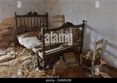 Letto matrimoniale in legno con sedia e bottiglie di vino in cestini in casa abbandonata, Chaos, vandalismo, letto, letto matrimoniale, Letto matrimoniale, letto singolo Foto Stock