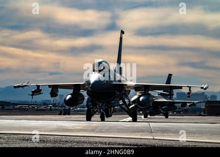 Due falchi F-16 assegnati alla 148th Fighter Wing, alla base della Guardia Nazionale aerea di Duluth, Minnesota, taxi per la pista prima di decollo per una missione Red Flag-Nellis 22-1 alla base dell'aeronautica di Nellis, Nevada, 28 gennaio 2022. I partecipanti conducono una serie di scenari, tra cui la difesa contro l'aria, la soppressione offensiva contro l'aria delle difese aeree nemiche e l'interdizione offensiva contro l'aria. (STATI UNITI Air Force foto di William R. Lewis) Foto Stock