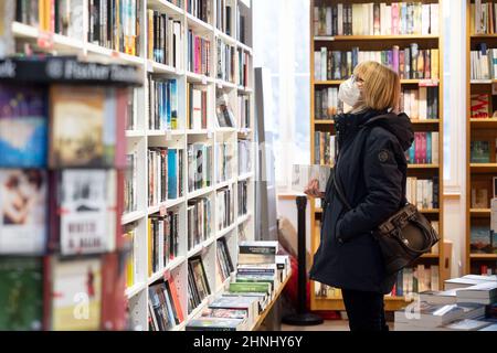 Stoccarda, Germania. 17th Feb 2022. Un cliente naviga in una libreria presso la libreria Osiander. Nonostante la terza cancellazione consecutiva della fiera, il Premio Fiera del Libro di Lipsia verrà nuovamente assegnato quest'anno. (Al dpa: 'Politico e diverso - i candidati per il Premio del Libro di Lipsia') credito: Marijan Murat/dpa/Alamy Live News Foto Stock