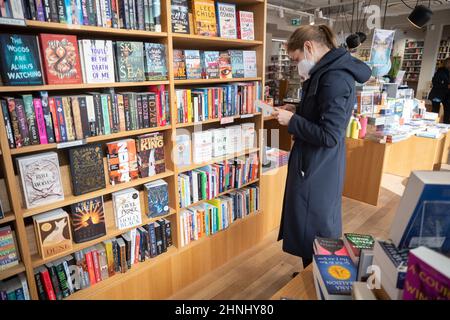 Stoccarda, Germania. 17th Feb 2022. Un cliente sta sfogliando una libreria presso la libreria Osiander. Credit: Marijan Murat/dpa/Alamy Live News Foto Stock