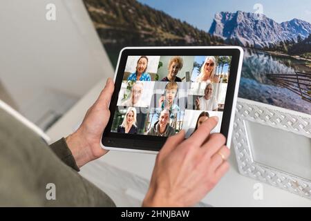 Comunicazione remota del lavoro. Businesswoman Holding Tablet avere un incontro online con il gruppo di colleghi fare videochiamata tramite computer seduto in moderno Foto Stock