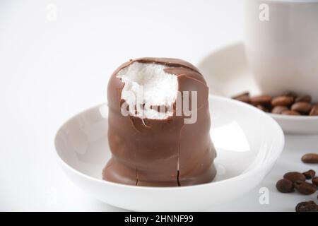 Krembo al cioccolato bianco sul tavolo. Una crema di marshmallow ricoperta di cioccolato che è popolare in Israele. Foto Stock