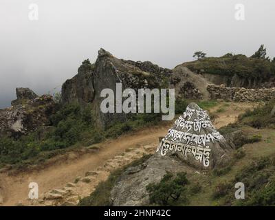 Mana scolpita e dipinta in Namche Bazaar, Nepal. Foto Stock