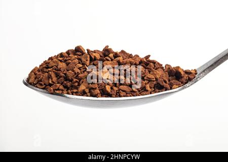 Caffè istantaneo su un cucchiaino su sfondo bianco Foto Stock